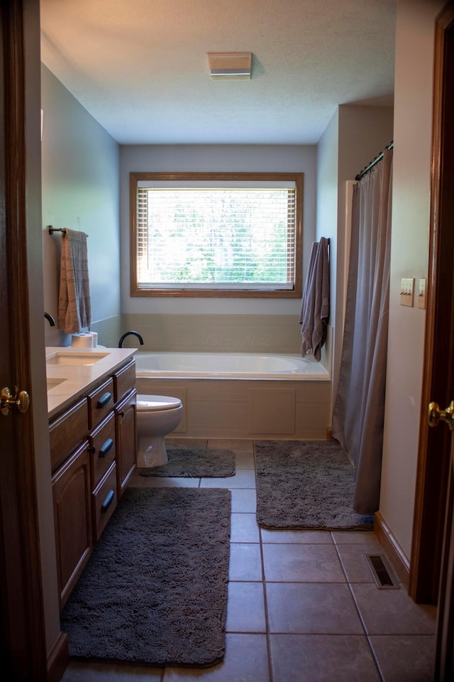 350 S Houston Pike, South Vienna, OH 45369 - full bathroom with toilet, a garden tub, vanity, and tile patterned flooring