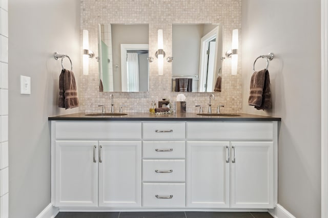 48 E 4th Ave, Columbus, OH 43201 - bathroom featuring double vanity, decorative backsplash, and baseboards