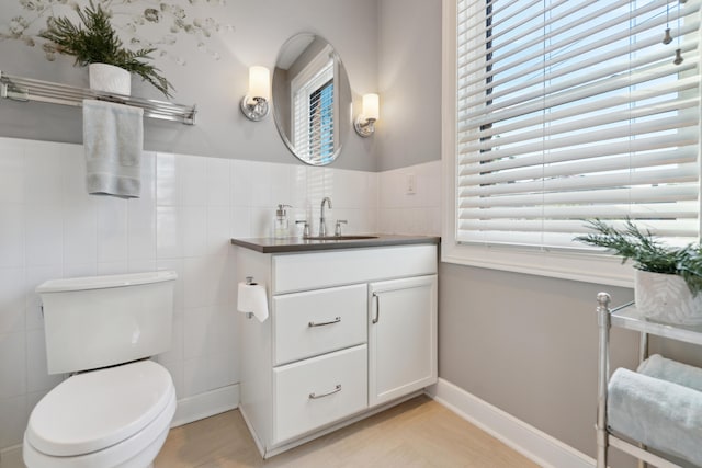 48 E 4th Ave, Columbus, OH 43201 - half bathroom with vanity, toilet, and tile walls
