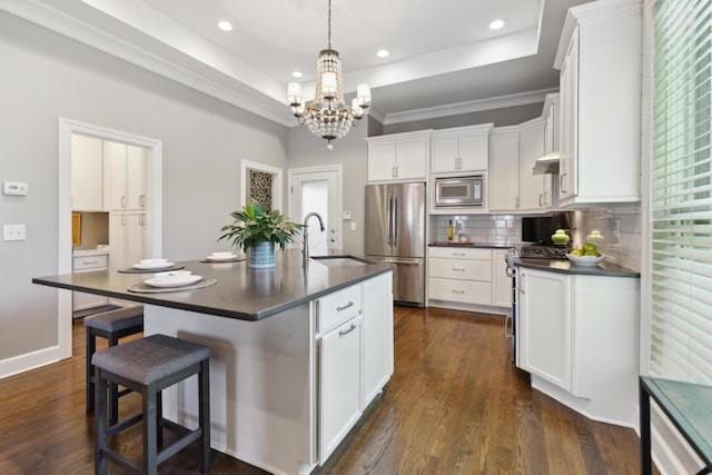 48 E 4th Ave, Columbus, OH 43201 - kitchen with stainless steel appliances, dark countertops, a sink, a chandelier, and white cabinets