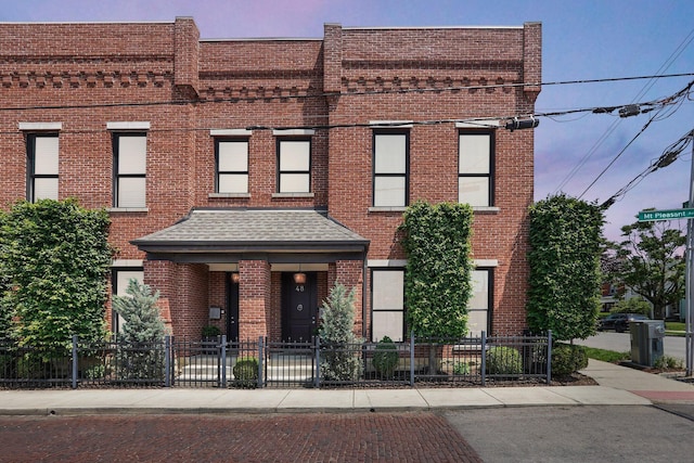 48 E 4th Ave, Columbus, OH 43201 - view of front of property with brick siding and a fenced front yard