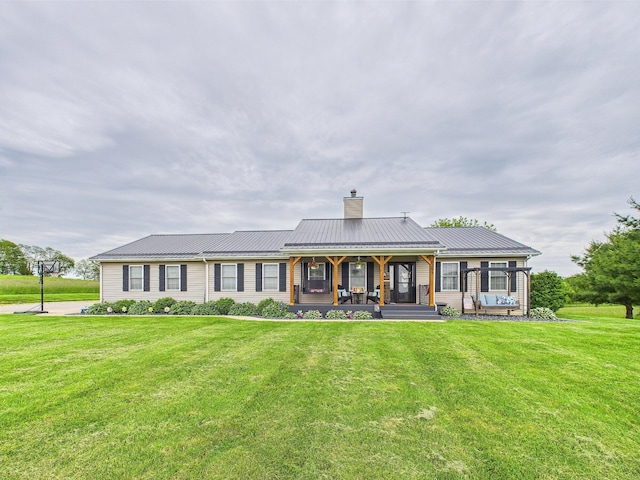 6297 Stage Coach Rd NW, Rushville, OH 43150 - view of front of house featuring a chimney, a front yard, and metal roof