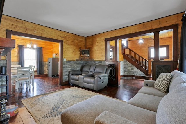 683 E 2nd St, Chillicothe, OH 45601 - living area with plenty of natural light, wooden walls, a fireplace, a chandelier, and stairway