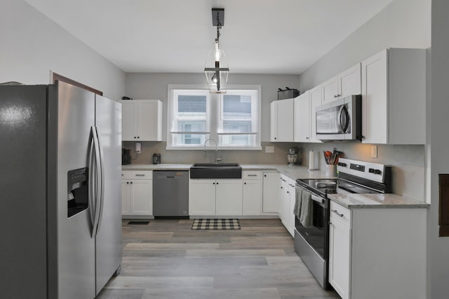 683 E 2nd St, Chillicothe, OH 45601 - kitchen with appliances with stainless steel finishes, a sink, and white cabinets