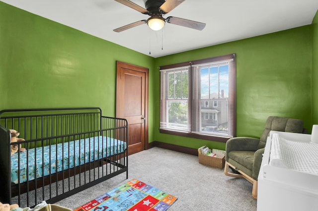683 E 2nd St, Chillicothe, OH 45601 - bedroom with baseboards, carpet flooring, a nursery area, and ceiling fan