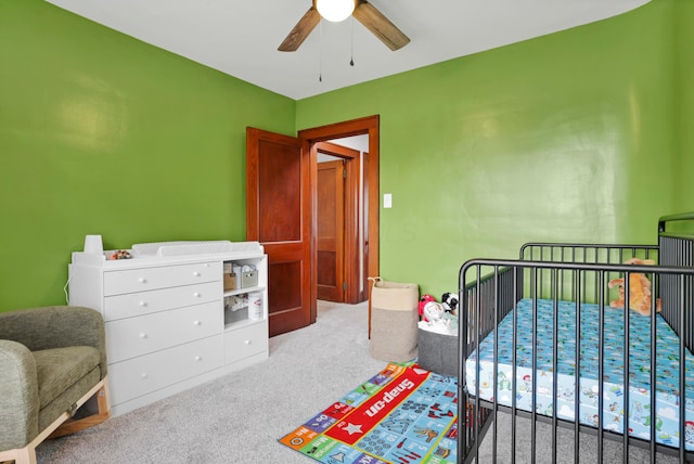 683 E 2nd St, Chillicothe, OH 45601 - bedroom featuring carpet floors, a crib, and ceiling fan