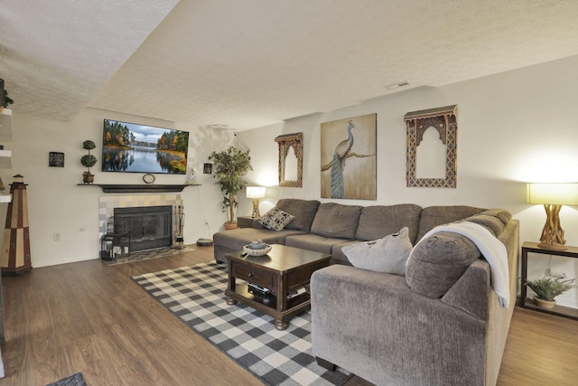 7400 Olympic Club Ct, Pickerington, OH 43147 - living room with a textured ceiling, wood finished floors, and a tiled fireplace