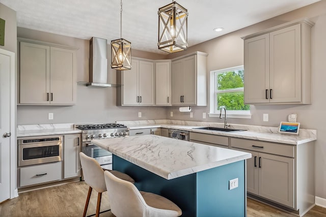 4483 County Road 124, Cardington, OH 43315 - kitchen featuring wall chimney exhaust hood, a sink, stainless steel appliances, light wood-style floors, and a breakfast bar