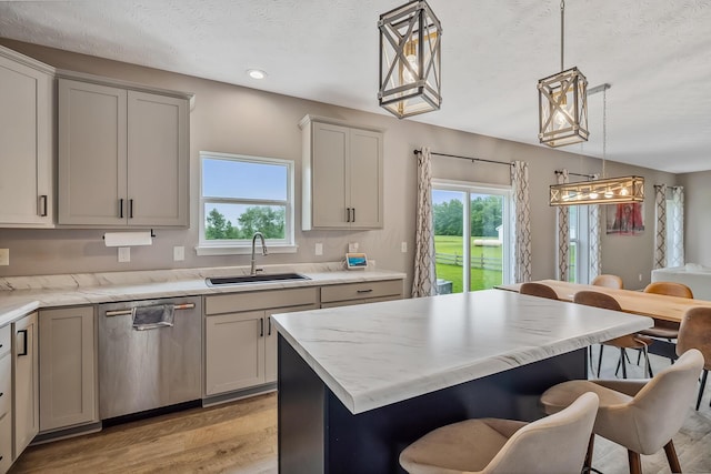 4483 County Road 124, Cardington, OH 43315 - kitchen with a sink, stainless steel dishwasher, light wood-style flooring, plenty of natural light, and a textured ceiling