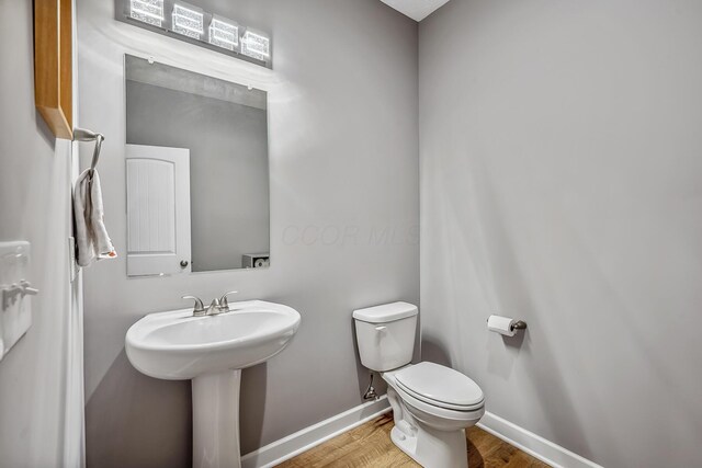 4483 County Road 124, Cardington, OH 43315 - bathroom with wood finished floors, toilet, baseboards, and a sink