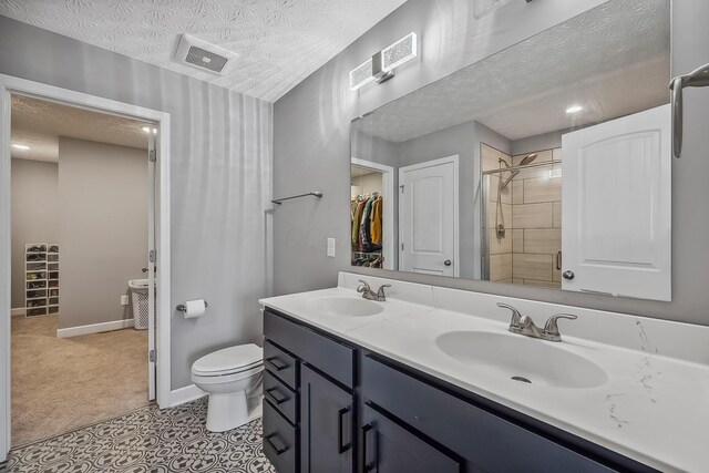 4483 County Road 124, Cardington, OH 43315 - full bathroom with a textured ceiling, double vanity, a shower stall, toilet, and baseboards