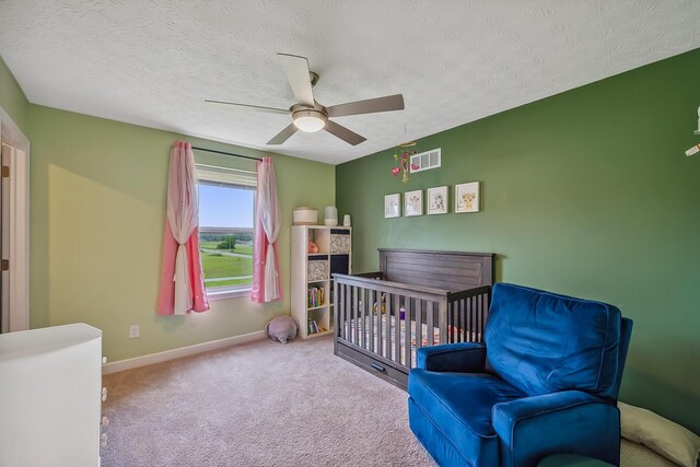 4483 County Road 124, Cardington, OH 43315 - carpeted bedroom with baseboards, a textured ceiling, a ceiling fan, and a nursery area