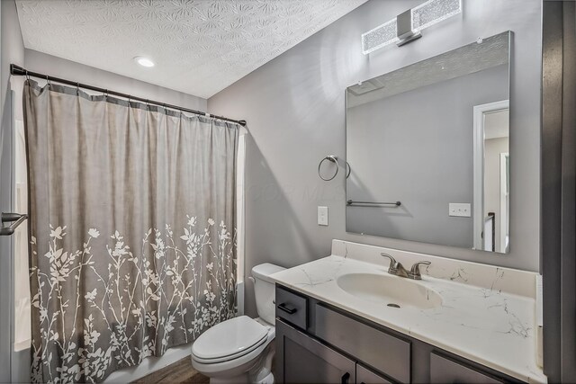 4483 County Road 124, Cardington, OH 43315 - bathroom with a textured ceiling, toilet, vanity, and shower / bath combo with shower curtain