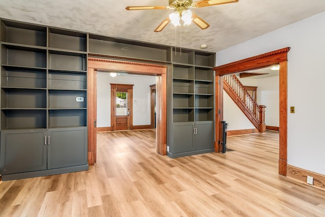 302 Oak St, Mount Vernon, OH 43050 - unfurnished living room featuring a ceiling fan, baseboards, stairway, and light wood-style floors