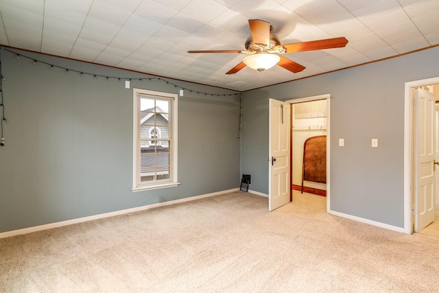 302 Oak St, Mount Vernon, OH 43050 - unfurnished bedroom featuring light colored carpet, baseboards, and a ceiling fan