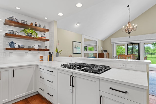 5518 Aryshire Ct, Dublin, OH 43017 - kitchen featuring black gas stovetop, vaulted ceiling, tasteful backsplash, open shelves, and a chandelier