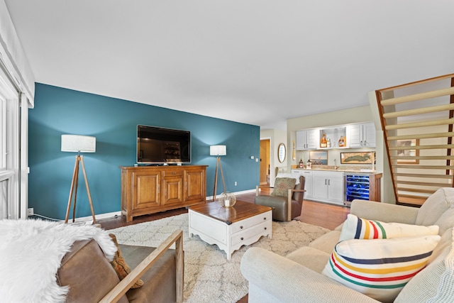 5518 Aryshire Ct, Dublin, OH 43017 - living area with a bar, beverage cooler, baseboards, and light wood finished floors