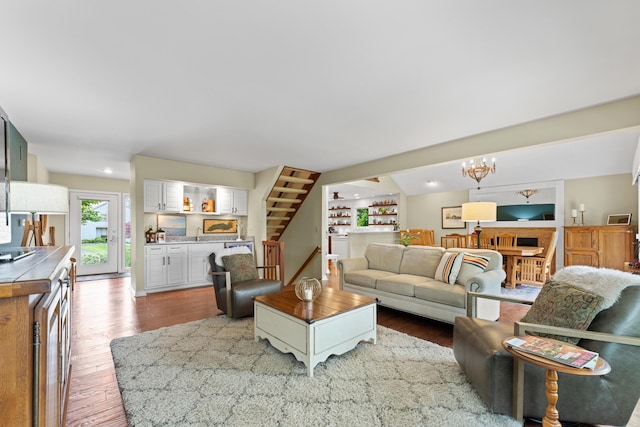 5518 Aryshire Ct, Dublin, OH 43017 - living room featuring wood finished floors, a chandelier, bar area, and stairway