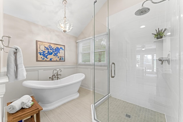5518 Aryshire Ct, Dublin, OH 43017 - full bath with a shower stall, a freestanding bath, lofted ceiling, a chandelier, and a wainscoted wall