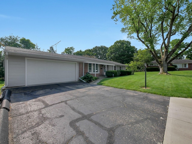 954 Circle Dr, Circleville, OH 43113 - single story home with a front yard, an attached garage, driveway, and brick siding