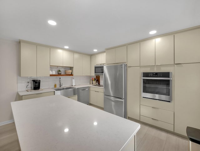 954 Circle Dr, Circleville, OH 43113 - kitchen with stainless steel appliances, cream cabinets, light countertops, tasteful backsplash, and recessed lighting