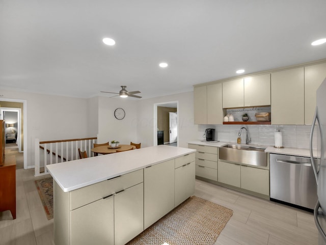 954 Circle Dr, Circleville, OH 43113 - kitchen featuring cream cabinetry, dishwasher, tasteful backsplash, light countertops, and ceiling fan