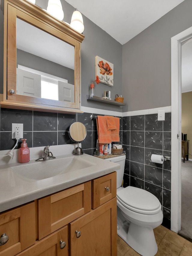 954 Circle Dr, Circleville, OH 43113 - half bath with tile walls, vanity, tile patterned flooring, and a wainscoted wall