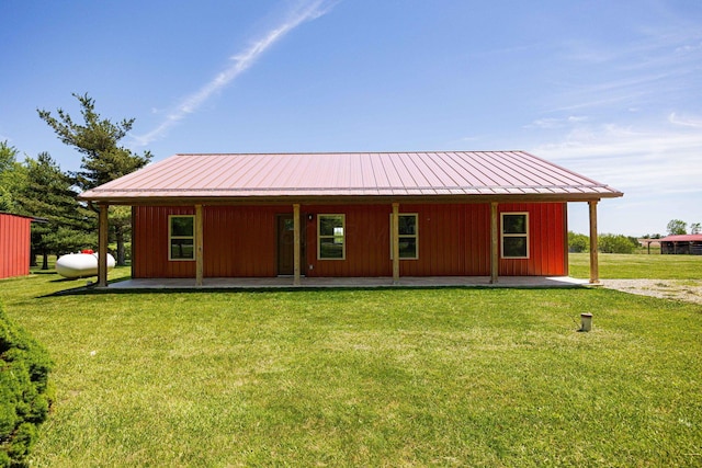 1674 Brock Rd NE, Bloomingburg, OH 43106 - back of house featuring a yard and metal roof