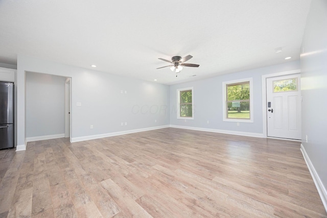 1674 Brock Rd NE, Bloomingburg, OH 43106 - unfurnished living room featuring ceiling fan, light wood-style flooring, baseboards, and recessed lighting
