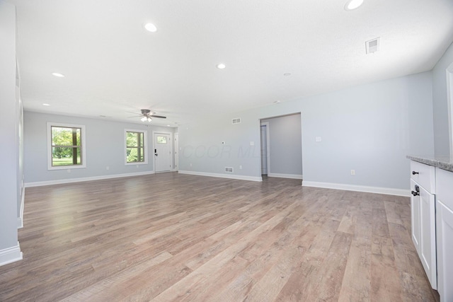1674 Brock Rd NE, Bloomingburg, OH 43106 - unfurnished living room featuring ceiling fan, light wood-style floors, baseboards, and recessed lighting