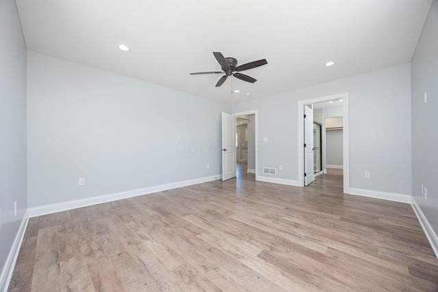 1674 Brock Rd NE, Bloomingburg, OH 43106 - unfurnished bedroom featuring light wood finished floors, recessed lighting, baseboards, a spacious closet, and a ceiling fan
