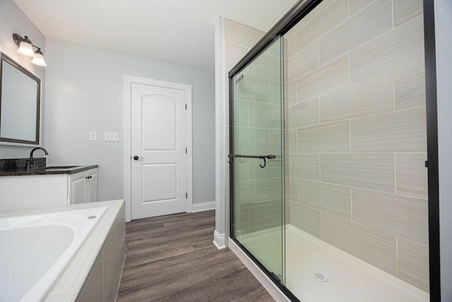1674 Brock Rd NE, Bloomingburg, OH 43106 - bathroom with a shower stall, vanity, wood finished floors, and a bath
