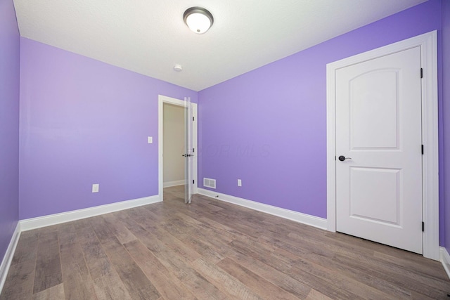 1674 Brock Rd NE, Bloomingburg, OH 43106 - unfurnished bedroom with wood finished floors and baseboards