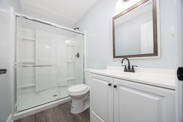 1674 Brock Rd NE, Bloomingburg, OH 43106 - full bathroom featuring a shower stall, vanity, toilet, and wood finished floors