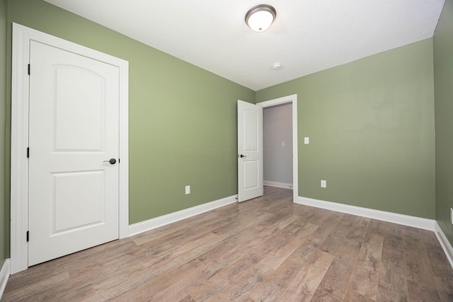 1674 Brock Rd NE, Bloomingburg, OH 43106 - unfurnished bedroom featuring light wood-style flooring and baseboards