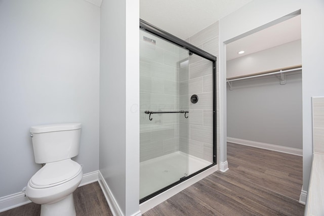 1674 Brock Rd NE, Bloomingburg, OH 43106 - full bathroom with a shower stall, toilet, wood finished floors, baseboards, and a spacious closet
