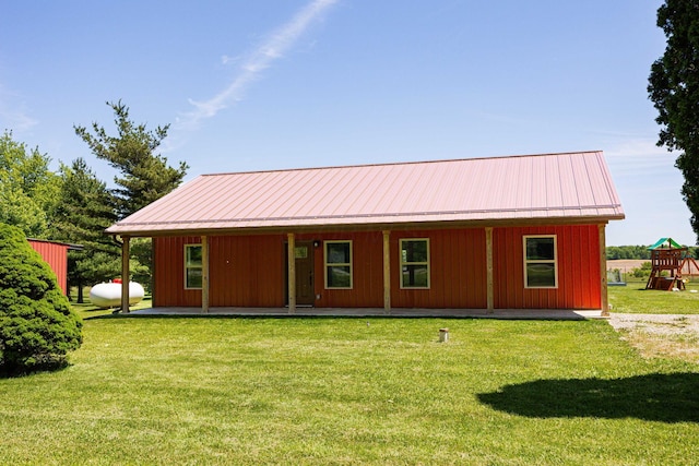 1674 Brock Rd NE, Bloomingburg, OH 43106 - view of front facade with a porch, a front lawn, a playground, and metal roof