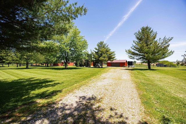1674 Brock Rd NE, Bloomingburg, OH 43106 - view of front of property with gravel driveway, a front lawn, an outbuilding, and a garage