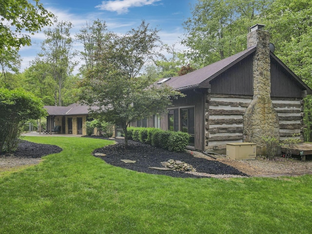 13115 Jack Run Rd, Rockbridge, OH 43149 - back of property featuring a yard, a chimney, and log exterior