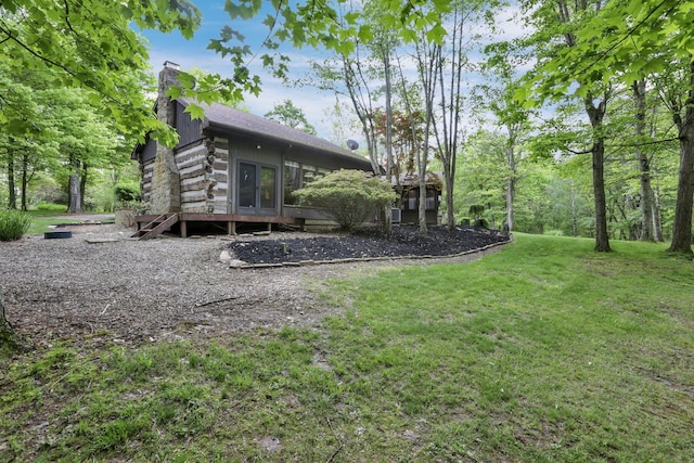 13115 Jack Run Rd, Rockbridge, OH 43149 - rear view of house with a chimney, a yard, a shingled roof, and log exterior