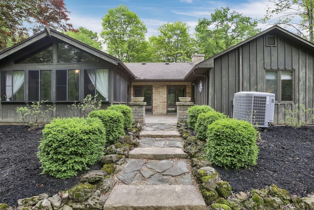 13115 Jack Run Rd, Rockbridge, OH 43149 - view of front of home with central air condition unit, board and batten siding, and a chimney