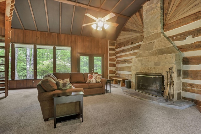 13115 Jack Run Rd, Rockbridge, OH 43149 - carpeted living area featuring vaulted ceiling, a ceiling fan, wood walls, and a stone fireplace