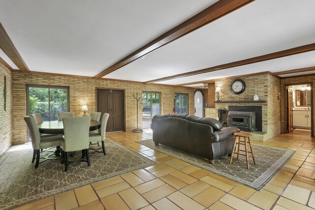13115 Jack Run Rd, Rockbridge, OH 43149 - living room with brick wall, beamed ceiling, and a brick fireplace