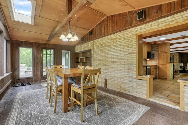 13115 Jack Run Rd, Rockbridge, OH 43149 - dining space with wooden walls, a chandelier, and a skylight