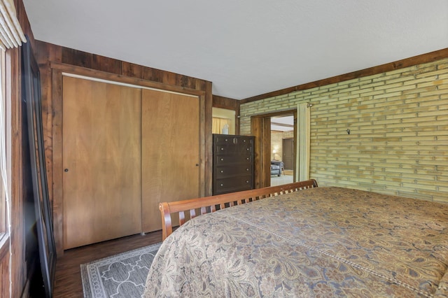 13115 Jack Run Rd, Rockbridge, OH 43149 - bedroom featuring a closet, wood finished floors, wooden walls, and brick wall