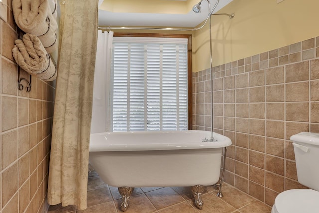 13115 Jack Run Rd, Rockbridge, OH 43149 - bathroom with tile walls, a freestanding tub, toilet, plenty of natural light, and tile patterned floors