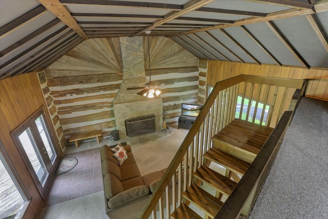 13115 Jack Run Rd, Rockbridge, OH 43149 - unfurnished living room with wooden walls, vaulted ceiling, ceiling fan, a fireplace, and carpet floors