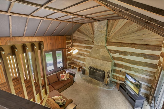 13115 Jack Run Rd, Rockbridge, OH 43149 - unfurnished living room featuring wood walls, vaulted ceiling, and a stone fireplace