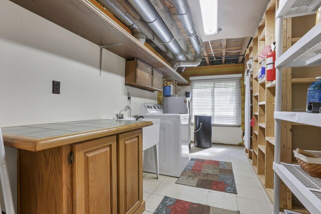 13115 Jack Run Rd, Rockbridge, OH 43149 - washroom with washer / dryer, water heater, and light tile patterned floors