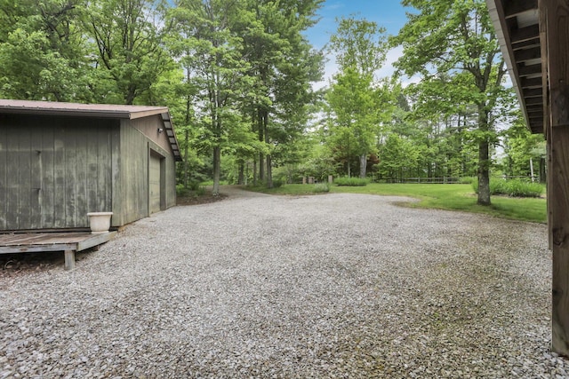 13115 Jack Run Rd, Rockbridge, OH 43149 - view of yard featuring an outbuilding, view of wooded area, and a garage
